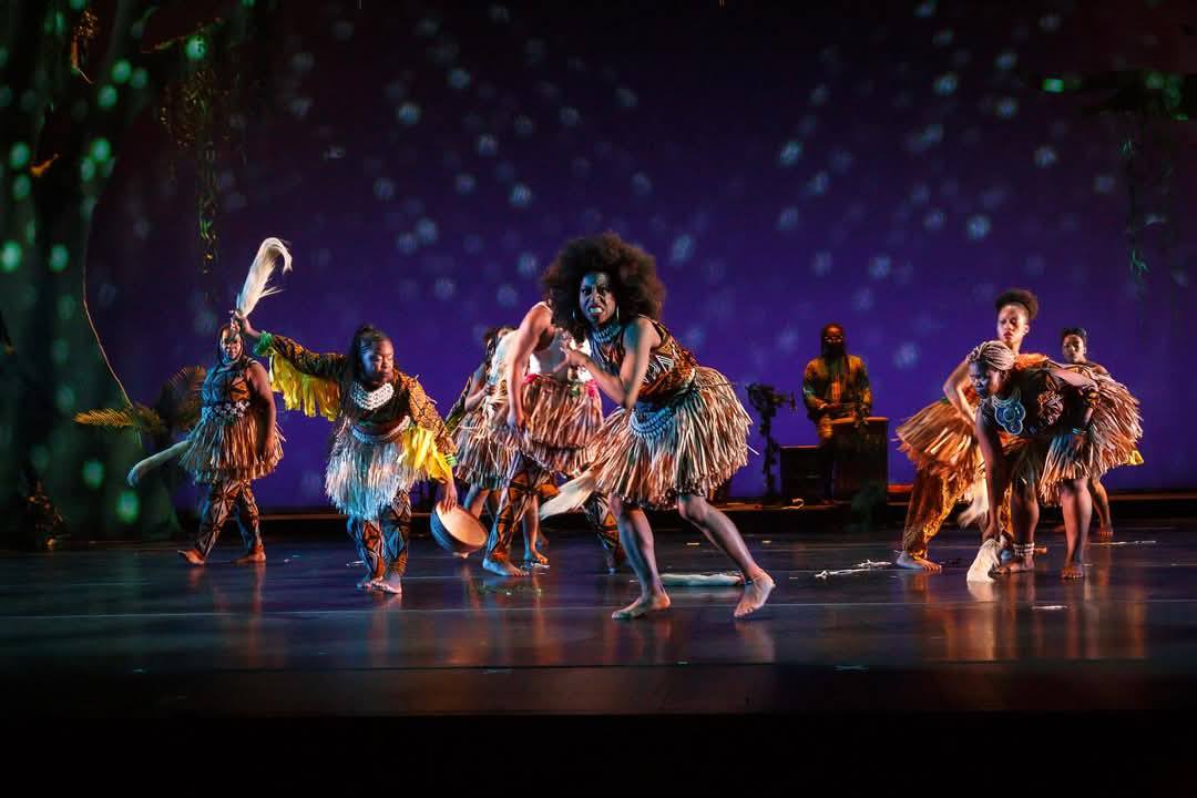 Siren ensemble in vibrant grass skirts performing at BAM DanceAfrica 2024