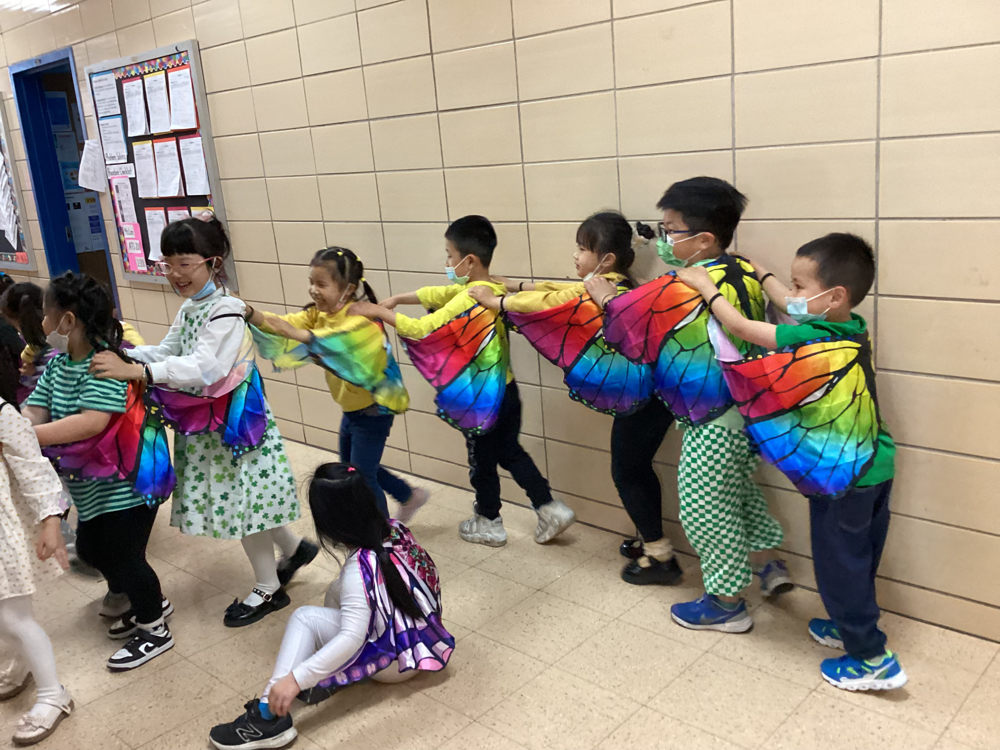 Children wearing colorful butterfly wings during arts-in-education residency