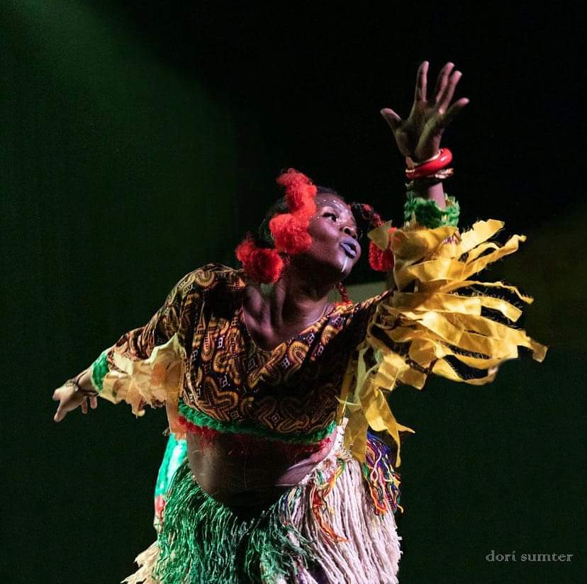 Mafor Mambo Tse in vibrant costume during a powerful dance performance