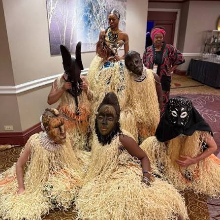 Siren Juju dancers in masks and raffia costumes